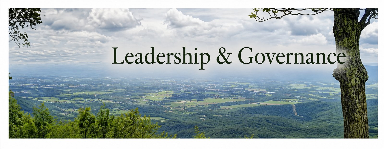 Mountain valley overlook framed by strong mature trees representing leadership, strength, and responsible governance at Mountain Heart Ministries.