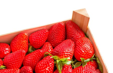 Fresh ripe strawberries in a wooden basket ready for storage